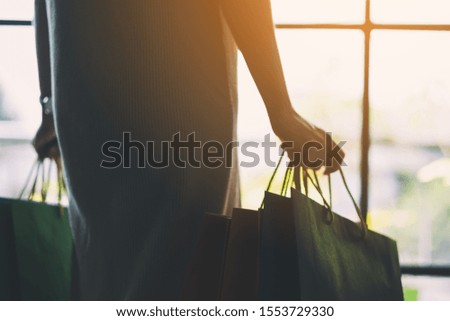 Closeup image of a woman holding colorful shopping bags
