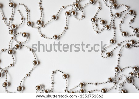 Silver beads for interior decoration on a white background. Decorations for the holiday. merry Christmas and happy New year.