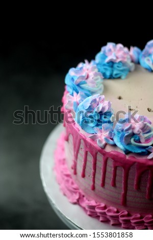 Pink and blue color cake  with black and grey background