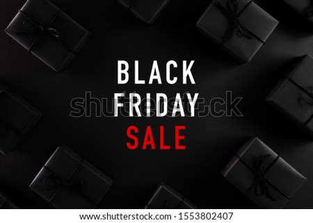 Top view of Black Friday Sale text with black gift box on dark background. Shopping concept boxing day and black Friday composition.