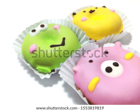 Multicolored animal cupcakes in paper cups on a white background with copy space.Close up.