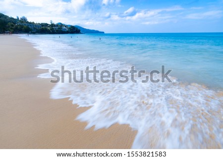 the sea wave splay white foam on the sand at the beach  Phuket sea Thailand wide angle low speed shutter shot