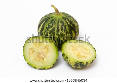 Small ripe striped sliced melons isolated on white background. Fresh KELEK is used in making pickles. Green fruits, organic, pickles, healthy eating, size and smallness concepts. Horizontal close-up.