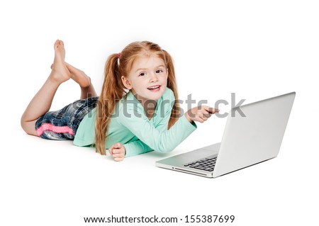 Young girl with laptop. Isolated on white background. Smiling and pointing at laptop computer.