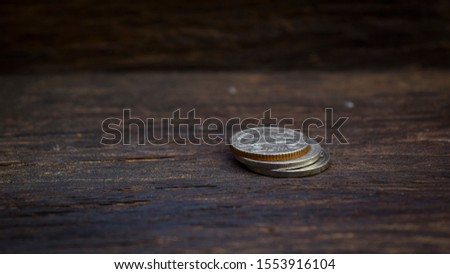 Conceptual picture set with silver coins on the old wooden floor