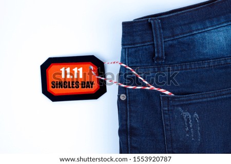 Online shopping of China, The jeans and shopping tag on a white background with copy space for text. 11.11 single's day sale concept