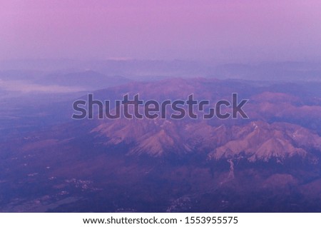 View from the airplane to the mountain range the High Tatras at the sunrise