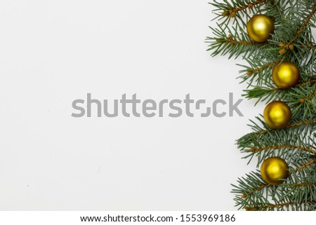 Creative Composition Useful for Christmas and New Year Greeting Card Created Using Decorative Balls and Green Pine Branches. Copy Space on The Left