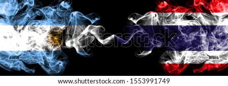 Argentina vs Thailand, Thai smoky mystic fire flags placed side by side. Thick colored silky abstract smoke flags concept