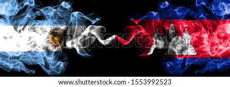 Argentina vs Cambodia, Cambodian smoky mystic fire flags placed side by side. Thick colored silky abstract smoke flags concept
