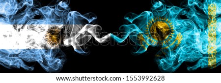Argentina vs Kazakhstan, Kazakhstani smoky mystic fire flags placed side by side. Thick colored silky abstract smoke flags concept