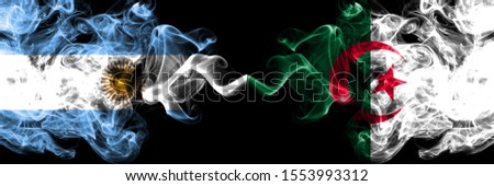Argentina vs Algeria, Algerian smoky mystic fire flags placed side by side. Thick colored silky abstract smoke flags concept