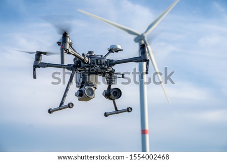 Industrial drone equipped with two cameras for inspection of rotor blades on wind turbines Royalty-Free Stock Photo #1554002468