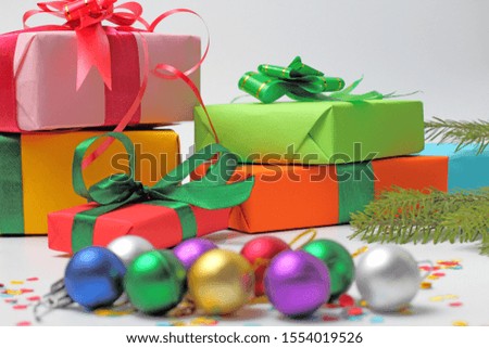 New Year's gifts under the branches of a Christmas tree on a white background concept of a family holiday.