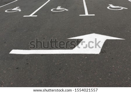 Road marking on the asphalt with parking spaces for the disabled