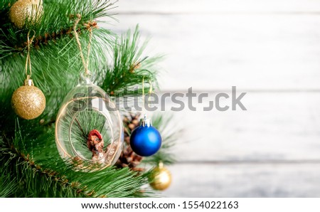 Christmas card with decorated Christmas toys on the tree with a place for your congratulations