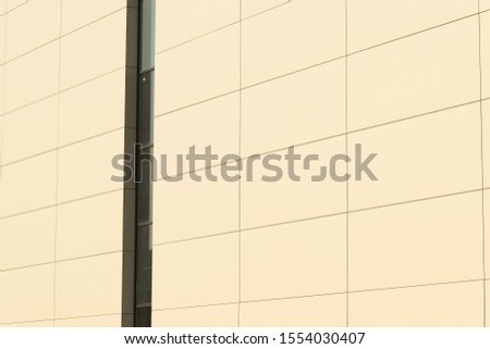 Geometric color elements of the building facade with planes, lines, corners with highlights and reflections for an abstract background and texture of gray, orange, blue colors. Place for text