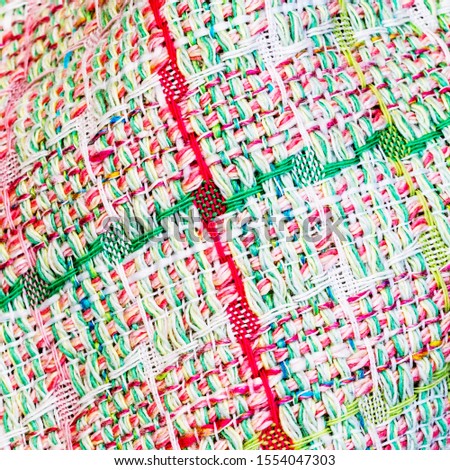 Abstract multicolor boucle cloth texture, close up fashion background. Multicolored plaid tweed fabric. Fashionable clothes square  structure background.