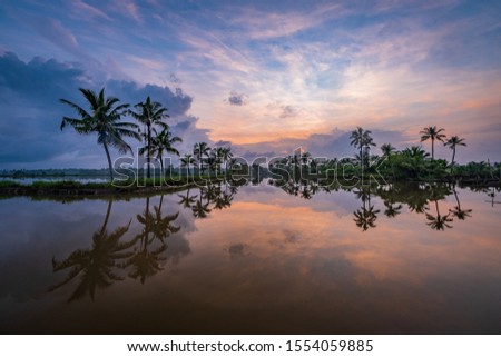 Kadamakkudy, Kerala - Beautiful sunrise view from Kerala Landscape backwater taken on Sep 2019 Royalty-Free Stock Photo #1554059885