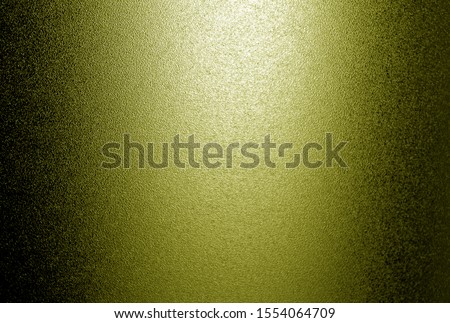 Ground glass texture with light in yellow tone. Abstract background and pattern for designers.