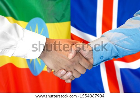 Business handshake on the background of two flags. Men handshake on the background of the Ethiopia and Iceland flag. Support concept