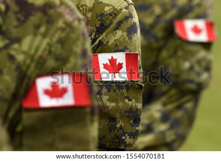 Flag of Canada on military uniform. Canadian soldiers. Army of Canada. Remembrance Day. Canada Day. Royalty-Free Stock Photo #1554070181