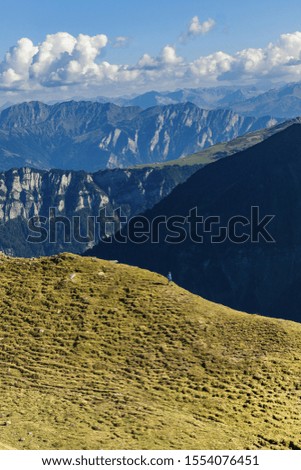 Sharp Alps peaks, rocks without people. View over Alpine rocks above deep vallyes to far horizon