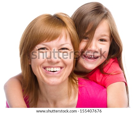 Portrait of a happy daughter piggyback ride her mother, isolated over white