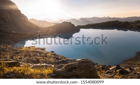 Beautiful panoramic view of a glacier lake in the Swiss mountain. Landscape during a colorful and vibrant sunset in fall Season. Taken in Wildsee lake, Swiss Alps, Switzerland, Europe