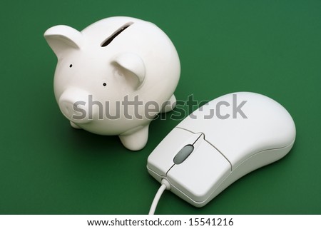 Piggy bank with computer mouse on a green background