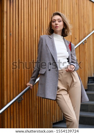 Girl model in a coat. Street style and fashion photo. Professional model.