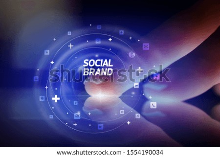 Finger touching tablet with social media icons and SOCIAL BRAND