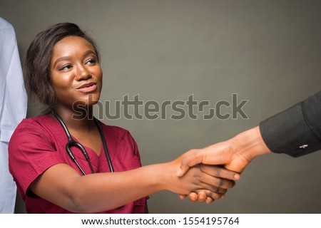 female doctor shakes a person's hand