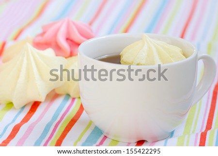 Pink colored meringue and a teacup