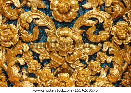 Thai traditional golden peonies flower or kanok pattern design texture wall for temple.