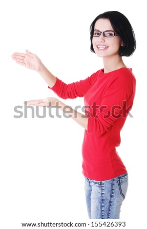 Happy , excited young woman presenting copy space on her palm, isolated on white 