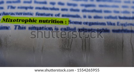 mixotrophic nutrition biological word written on english language with water drops abstract background 