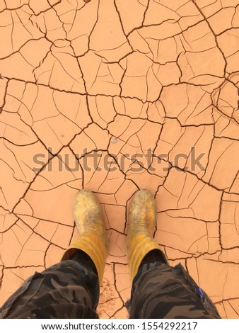 A picture of my boots over the cracked sand background