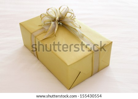 gift box with ribbon bow on bed