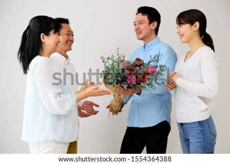 Portrait of two households with a bouquet