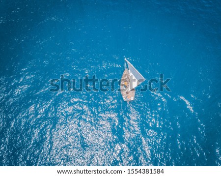 Drone picture of a traditional dhow sailboat sailing in the Indian ocean, Tanzania.