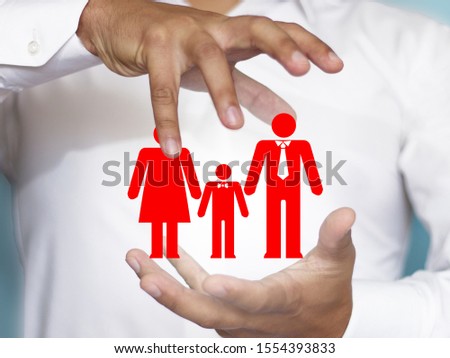 The concept of family safety, health, life. Dad, mom and baby. Insurance is related to the image of a family under the protection of human hands. Royalty-Free Stock Photo #1554393833