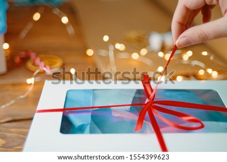 Christmas composition with present box. Festive gift box inside with red ribbon.