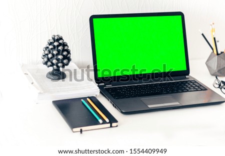 Green screen laptop, notebook, smartphone, background. Workplace at home during the pandemic. The quarantine concept of stay home stop coronavirus COVID-19 spreading.