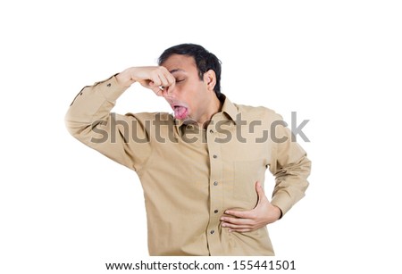 Closeup portrait of handsome man covering his nose, looks at you, something stinks, isolated on white background