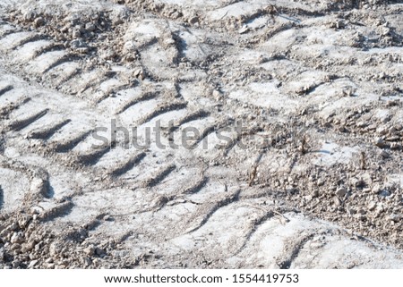 traces of the tread of a truck on the ground