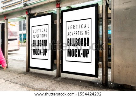 Mock up two perspective blank vertical billboard with clipping path at bus stop with metal frame on street walk, blurred people walking, empty space for advertising or information
