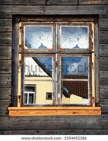 Exterior of old house with window.