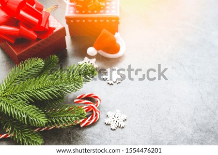 Christmas holiday background with Santa hat and fir branches decoration candy cane pine tree gift box and Festive Happy New Year object , top view copy space