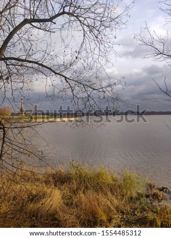 Volga riverbank in autumn with dead grass ahd clouds